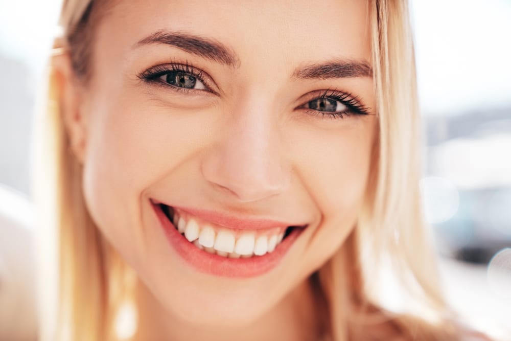 Confident patient smiling after cosmetic dental care